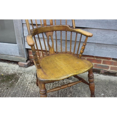 589 - A modern Windsor elbow chair with panel seat, spindle and lath carved splat back, on turned and stre... 