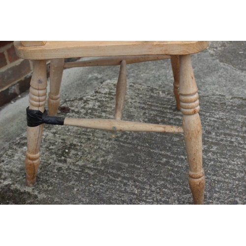 594 - A beech Windsor lath back farmhouse elbow chair (damages)