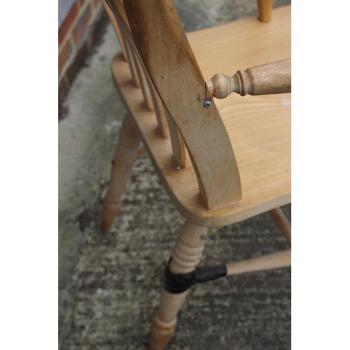 594 - A beech Windsor lath back farmhouse elbow chair (damages)