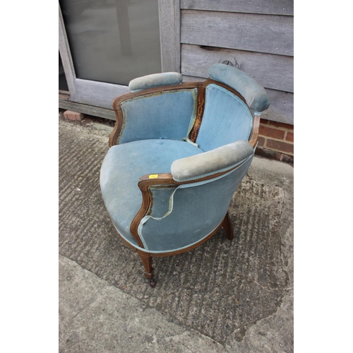 597 - An Edwardian rosewood and inlaid tub-shape chair, upholstered in a blue velour, on square taper supp... 