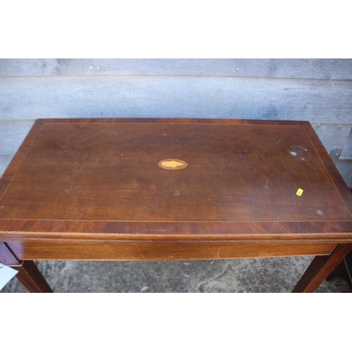 651 - A mahogany and banded and inlaid fold-over top card table, on square taper supports, 36