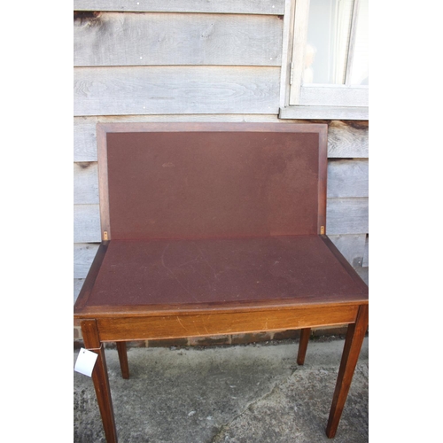 651 - A mahogany and banded and inlaid fold-over top card table, on square taper supports, 36