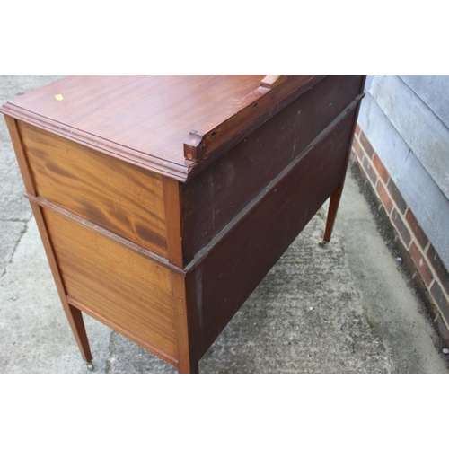 653 - An Edwardian walnut box and ebony strung ledge back sideboard, fitted one long drawer over cupboards... 