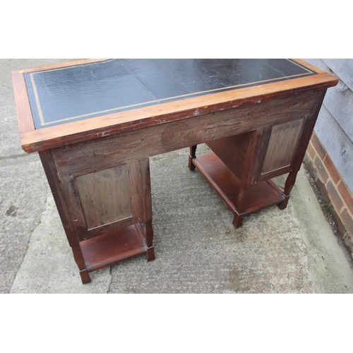 654 - An Arts & Crafts walnut break bowfront double pedestal desk with tooled lined top, fitted seven draw... 