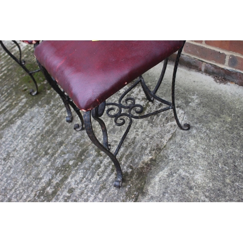 655 - A pair of early 20th century wrought iron high back chairs, on scroll supports, 49