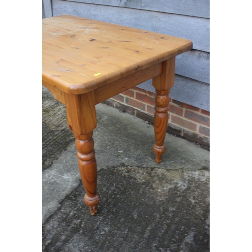 657 - A waxed pine table, on turned supports, 40