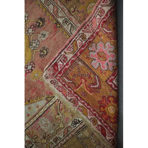 667 - A Caucasian rug with central medallion on a red ground and multi-bordered in shades of yellow, brown... 