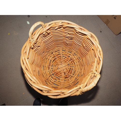 674 - A woven bamboo log basket with carry handles, 24