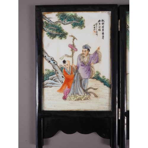 90 - A Chinese four-section folding screen, decorated figures in landscapes, 10 1/4