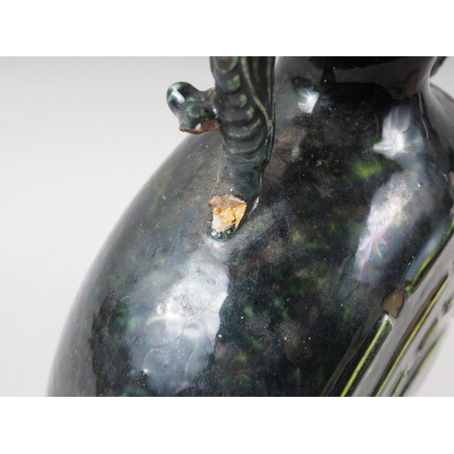 93 - A Chinese monochrome dark green glazed moonflask with Yin and Yang design and shaped handles, 9 3/4