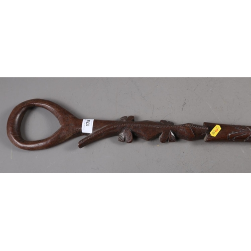 178 - An African (Ghana?) carved ironwood walking stick with loop handle, lizard and figure decorated shaf... 