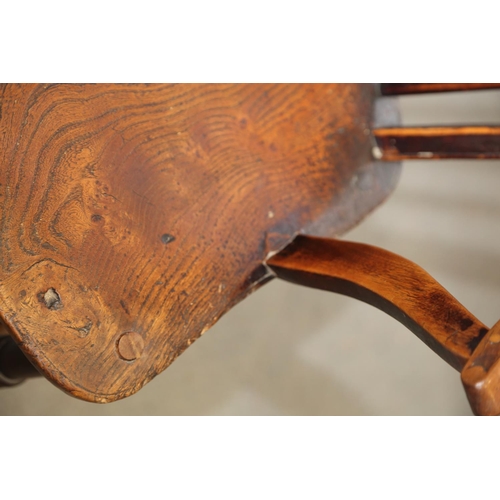 521 - A 19th century Windsor wheel back elbow chair with panel seat, on turned and stretchered supports