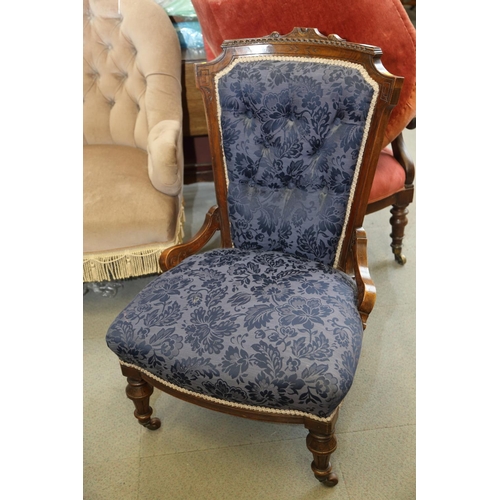 544 - A late Victorian carved walnut showframe salon chair, button upholstered in a blue figured brocade, ... 