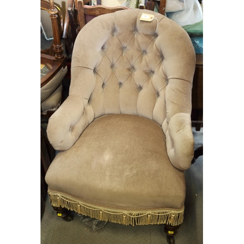 545 - A late 19th century tub-shape armchair, button upholstered in a mushroom velour, on turned and casto... 