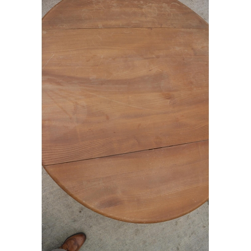 620 - A 1960s Ercol light elm drop leaf dining table, on splay supports, 48