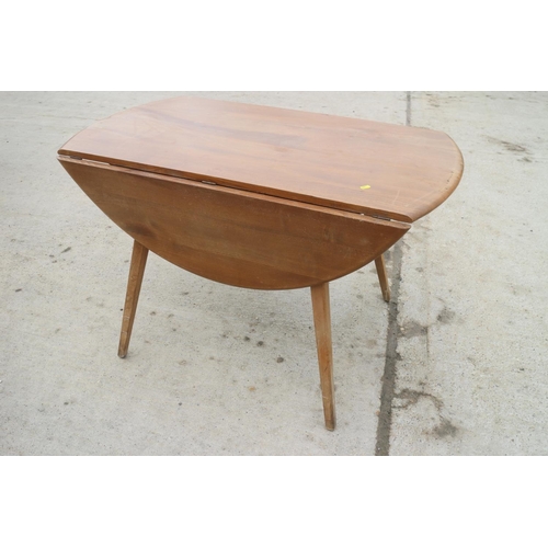 620 - A 1960s Ercol light elm drop leaf dining table, on splay supports, 48