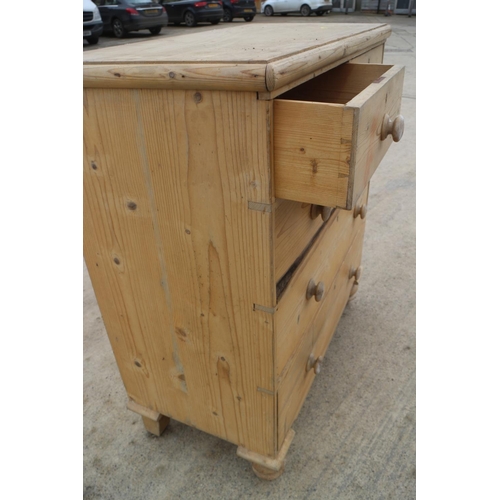 662 - A waxed pine chest of two short and three long drawers with knob handles, on turned supports, 36 1/2... 