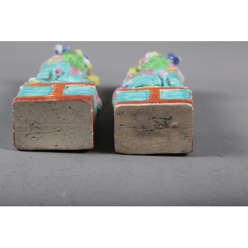 87 - A pair of Chinese polychrome decorated Dogs of Fo, on square bases, 9