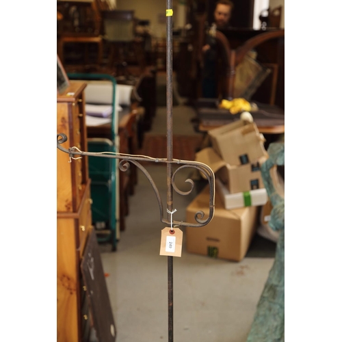 249 - A wrought iron standard lamp, on tripod splay supports, 63 1/2