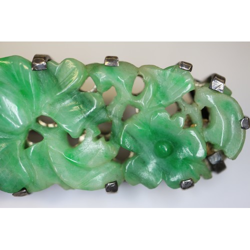 346 - A Chinese floral carved green jade and white metal mounted brooch and a similar bracelet