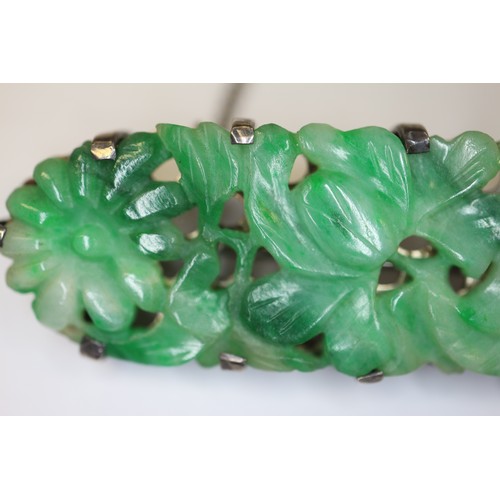 346 - A Chinese floral carved green jade and white metal mounted brooch and a similar bracelet