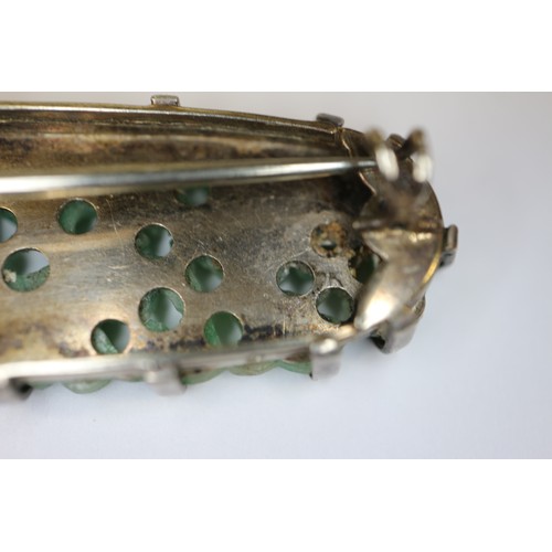 346 - A Chinese floral carved green jade and white metal mounted brooch and a similar bracelet