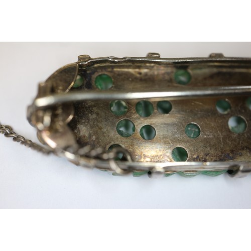 346 - A Chinese floral carved green jade and white metal mounted brooch and a similar bracelet