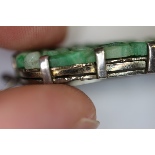 346 - A Chinese floral carved green jade and white metal mounted brooch and a similar bracelet