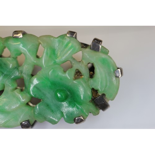 346 - A Chinese floral carved green jade and white metal mounted brooch and a similar bracelet