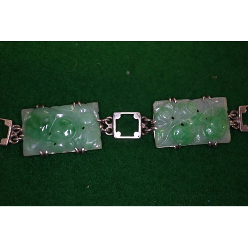 346 - A Chinese floral carved green jade and white metal mounted brooch and a similar bracelet