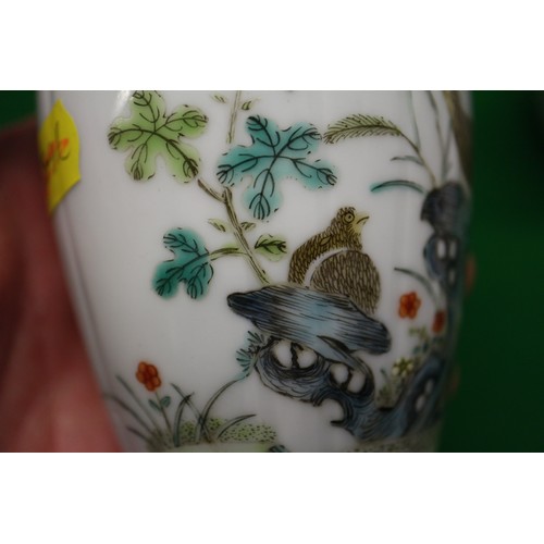 94 - A pair of Chinese famille verte baluster vases with flower, birds and insects in a landscape design ... 