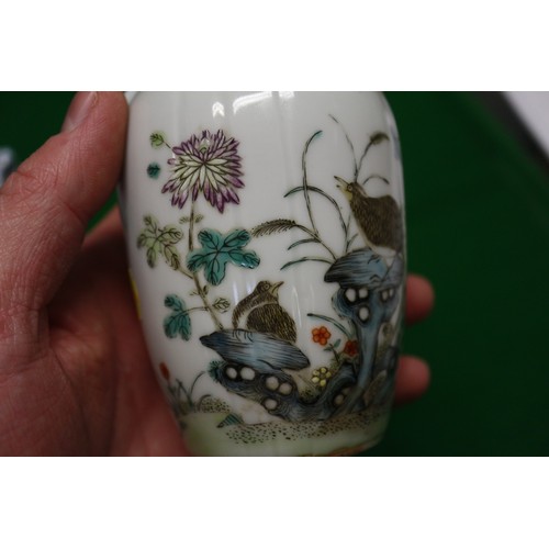 94 - A pair of Chinese famille verte baluster vases with flower, birds and insects in a landscape design ... 