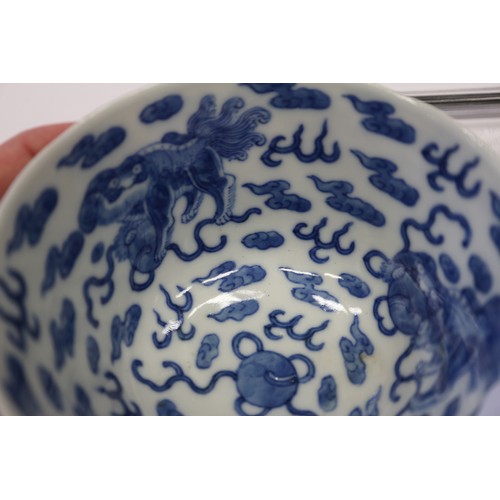 96 - A Chinese porcelain blue and white tea bowl, decorated mythical beasts and clouds with four-characte... 