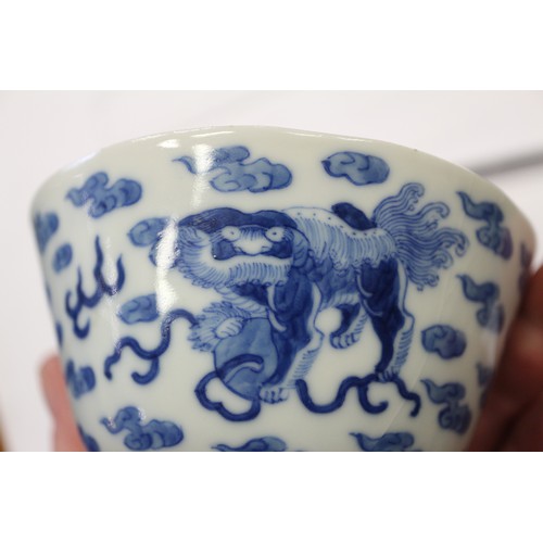 96 - A Chinese porcelain blue and white tea bowl, decorated mythical beasts and clouds with four-characte... 