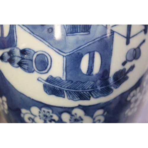 101 - A Chinese blue and white ginger jar, decorated panels with vases, tables and flowers, 5 1/2