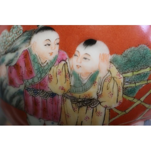 106 - A 20th century Chinese porcelain double gourd vase, decorated children playing on a coral powder gro... 