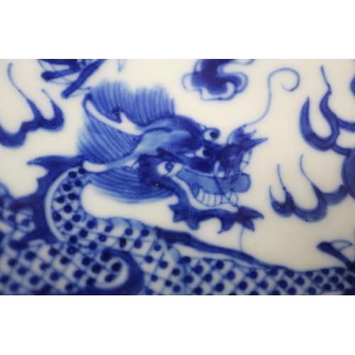 95 - A pair of Chinese porcelain blue and white dishes, decorated dragons, clouds, and flaming pearls, ba... 