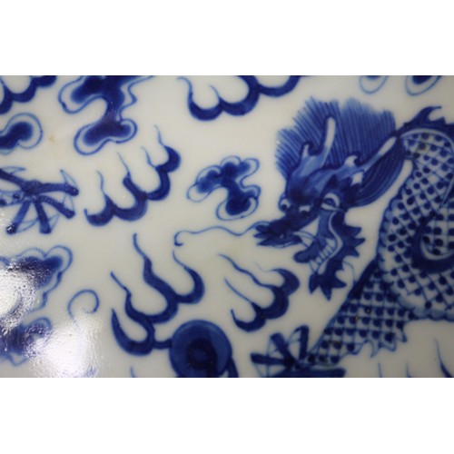 95 - A pair of Chinese porcelain blue and white dishes, decorated dragons, clouds, and flaming pearls, ba... 