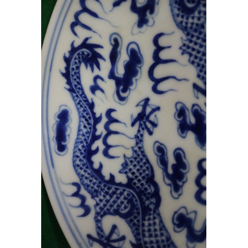 95 - A pair of Chinese porcelain blue and white dishes, decorated dragons, clouds, and flaming pearls, ba... 