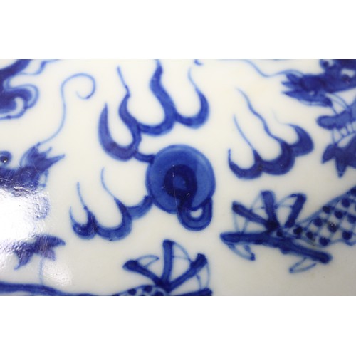 95 - A pair of Chinese porcelain blue and white dishes, decorated dragons, clouds, and flaming pearls, ba... 