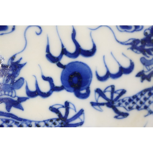 95 - A pair of Chinese porcelain blue and white dishes, decorated dragons, clouds, and flaming pearls, ba... 