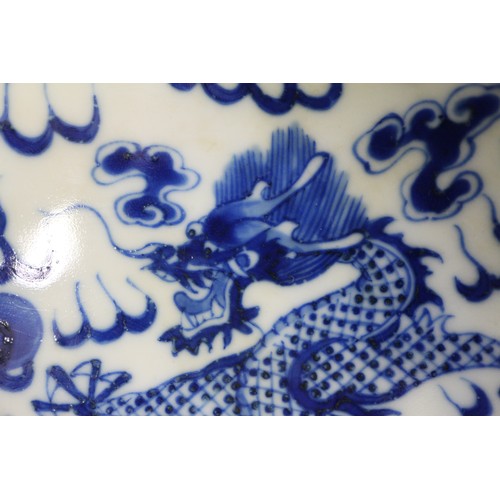 95 - A pair of Chinese porcelain blue and white dishes, decorated dragons, clouds, and flaming pearls, ba... 