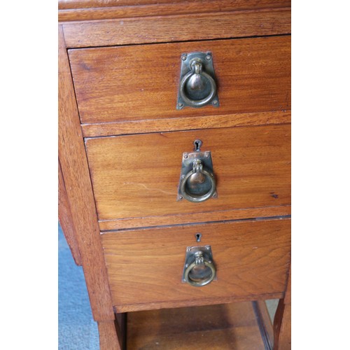 654 - An Arts & Crafts walnut break bowfront double pedestal desk with tooled lined top, fitted seven draw... 