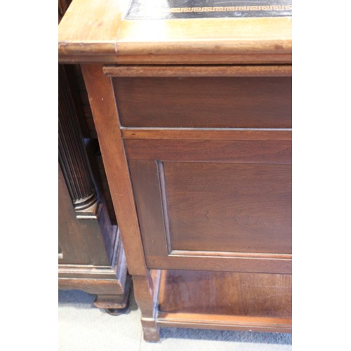 654 - An Arts & Crafts walnut break bowfront double pedestal desk with tooled lined top, fitted seven draw... 