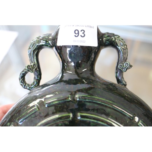 93 - A Chinese monochrome dark green glazed moonflask with Yin and Yang design and shaped handles, 9 3/4