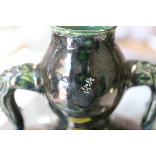 93 - A Chinese monochrome dark green glazed moonflask with Yin and Yang design and shaped handles, 9 3/4