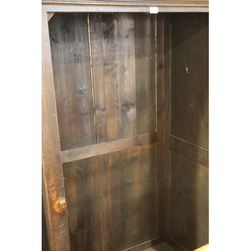 524 - A carved oak wardrobe of 17th century design enclosed linen fold panel door, on stile supports, 40 1... 