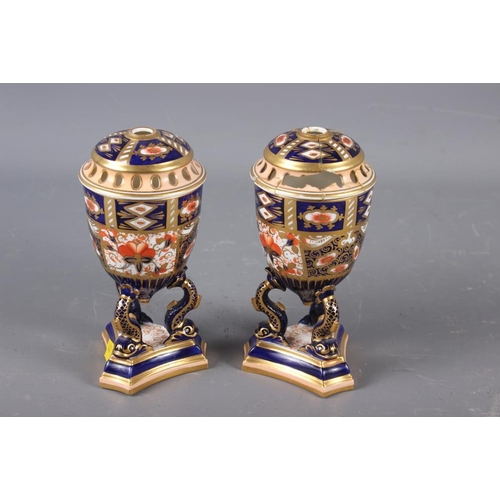 6 - A pair of Davenport Imari decorated pot-pourri vases and covers (one repaired with losses), on dolph... 