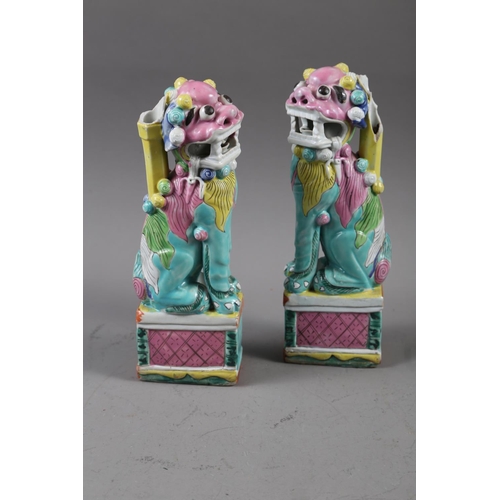 133 - A pair of Chinese polychrome decorated Dogs of Fo, on square bases, 9