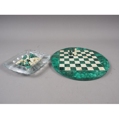 284 - A malachite and hardstone chess set, on circular inlaid malachite stone board, 8